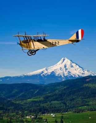 WAAAM biplane flying with Mt Hood in the background